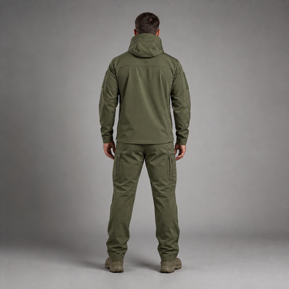 Man wearing green softshell jacket and utility trousers, full-body rear studio view