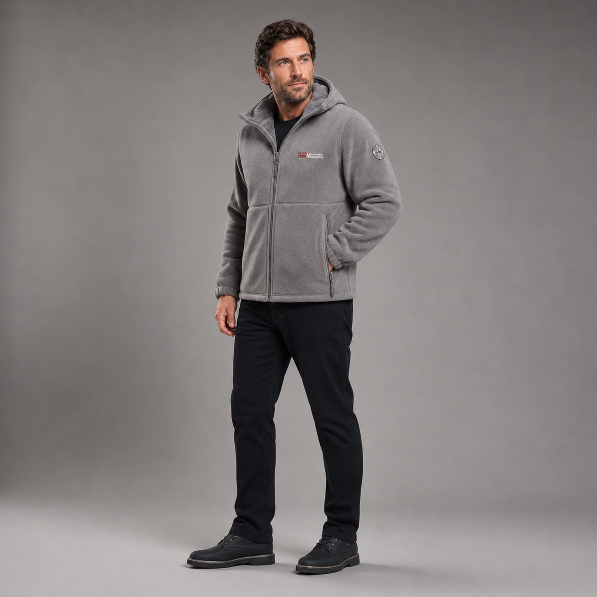 Man wearing gray thermal fleece jacket in full-body three-quarter studio view