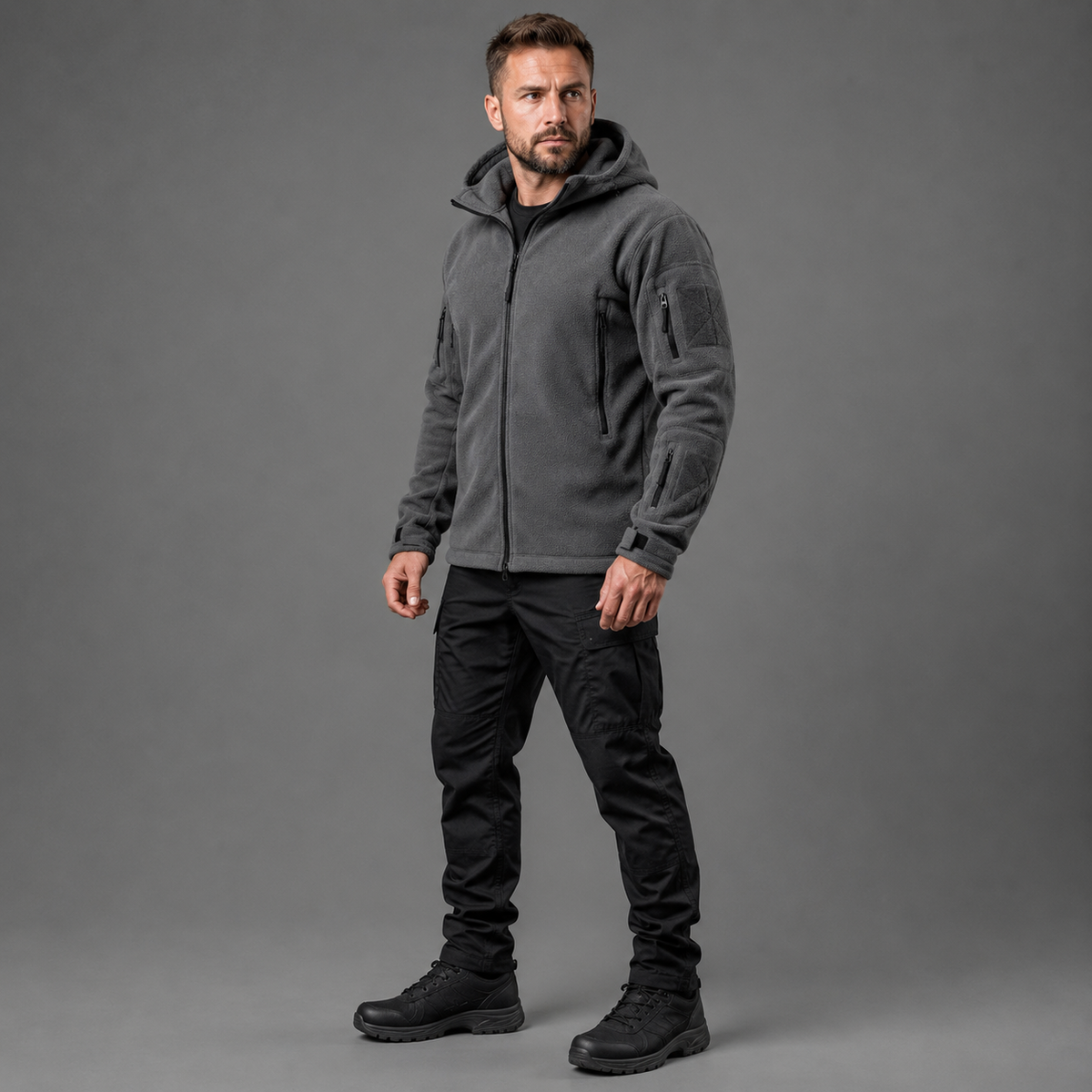 Man wearing gray tactical thermal fleece jacket in full-body studio view