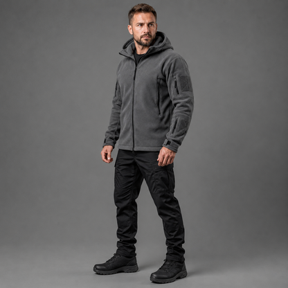 Man wearing gray tactical thermal fleece jacket in full-body studio view
